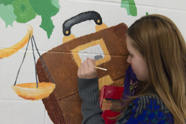 girl painting wynn mural